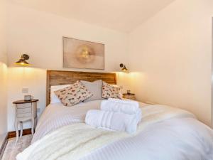 a bedroom with a large white bed with towels on it at 1 Bed in Thirsk oc-94728 in Thirsk