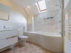 a bathroom with a tub and a toilet and a sink at 3 Bed in Consett oc-cn195 in Hunstanworth