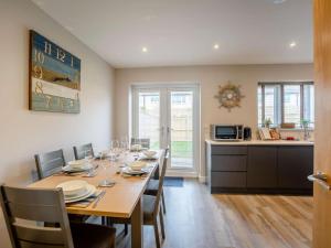 a dining room with a table and chairs and a kitchen at 3 Bed in Seahouses oc-81486 in Seahouses