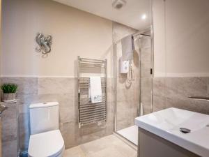 a bathroom with a shower and a toilet and a sink at 3 Bed in Seahouses oc-81486 in Seahouses +11 photos