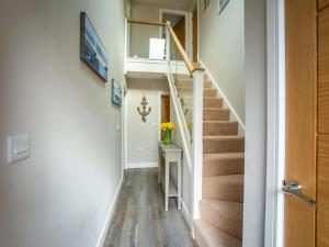 a hallway of a house with stairs and a table at 3 Bed in Seahouses oc-81486 in Seahouses