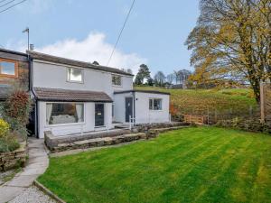 a white house with a lawn in front of it at 2 Bed in Barnoldswick oc-83775 in Barnoldswick