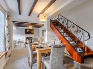a dining room with a table and a staircase at 2 Bed in Barnoldswick oc-83775 in Barnoldswick