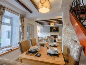 a dining room and living room with a wooden table at 2 Bed in Barnoldswick oc-83775 in Barnoldswick