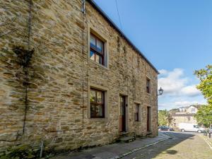 an old stone building with windows on a street at 2 Bed in Skipton oc-79093 in Skipton