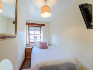 a small bedroom with a bed and a window at 2 Bed in Skipton oc-79093 in Skipton +6 photos