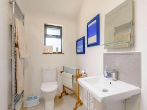 a bathroom with a sink and a toilet and a mirror at 1 Bed in Wareham oc-87150 in Stoborough