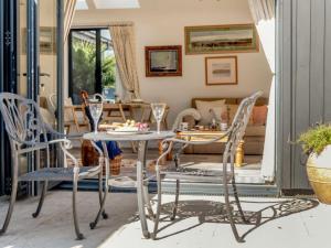 a living room with a table and chairs at 1 Bed in Wareham oc-87150 in Stoborough