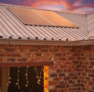 a roof with solar panels on top of a brick building at Romaic Guesthouse Welkom in Welkom