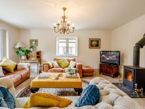 a living room with a couch and a fireplace at 3 Bed in Ilminster oc-77987 in Cudworth
