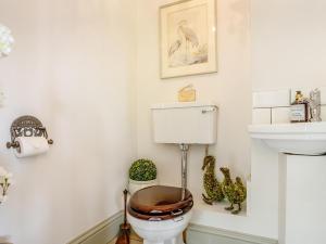a bathroom with a toilet with a wooden seat at 3 Bed in Ilminster oc-77987 in Cudworth +18 photos