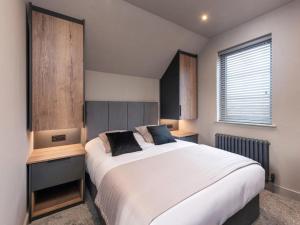a bedroom with a large white bed and a window at 4 Bed in Morpeth oc-95889 in Amble +22 photos