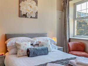 a bedroom with a bed with pillows and a chair at 1 Bed in Alnwick oc-94380 in Embleton