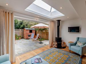 a living room with a fireplace and an open patio at 2 Bed in Bembridge oc-94115 in Bembridge