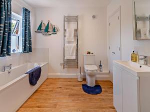 a bathroom with a tub and a toilet and a sink at 2 Bed in Bembridge oc-94115 in Bembridge +19 photos