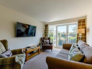 a living room with a couch and a chair at 3 Bed in Wooler oc-93544 in Wooler