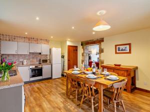 a kitchen and dining room with a wooden table at 3 Bed in Skipton oc-94259 in Airton
