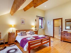 a bedroom with a large bed and a wooden floor at 3 Bed in Skipton oc-94259 in Airton