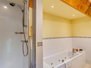 a bathroom with a bath tub and a shower at 3 Bed in Skipton oc-94259 in Airton +18 photos