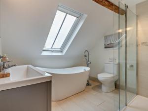 a bathroom with a tub and a toilet and a window at 3 Bed in Salisbury oc-66130 in Redlynch +18 photos