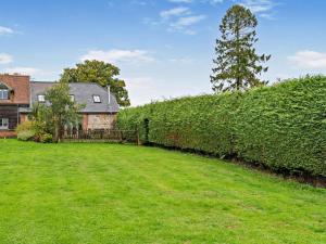 a hedge in front of a house with a yard at 3 Bed in Salisbury oc-66130 in Redlynch