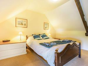 a bedroom with a large bed and a dresser at 4 Bed in Consett oc-cn108 in Hunstanworth