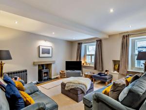 a living room with two couches and a fireplace at 3 Bed in Leyburn oc-76395 in Askrigg