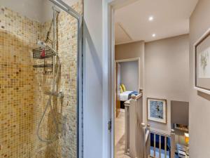 a bathroom with a walk in shower next to a brick wall at 3 Bed in Leyburn oc-76395 in Askrigg +17 photos