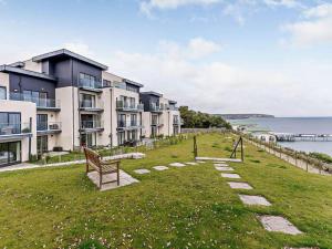a row of apartment buildings on a grassy hill next to the water at 2 Bed in Sandown oc-83617 in Sandown