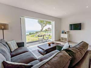 a living room with a couch and a large window at 2 Bed in Sandown oc-83617 in Sandown