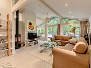 a living room with a couch and a fireplace at 3 Bed in Brockenhurst oc-47431 in Beaulieu