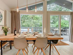 a dining room with a large wooden table and chairs at 3 Bed in Brockenhurst oc-47431 in Beaulieu