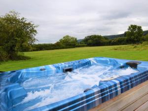 a hot tub in the middle of a field at 1 Bed in Bristol oc-85559 in Langford