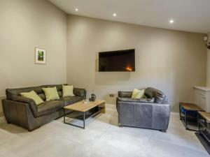 a living room with two couches and a tv at 4 Bed in Skipton oc-84017 in Rylstone