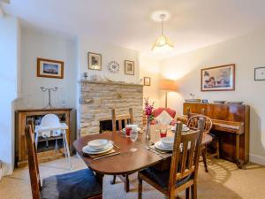 a dining room with a table and a piano at 2 Bed in Swanage oc-dc068 in Langton Matravers