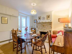 a living room with a table and chairs and a fireplace at 2 Bed in Swanage oc-dc068 in Langton Matravers