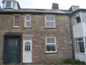 an old brick house with a green door at 2 Bed in Swanage oc-dc068 in Langton Matravers