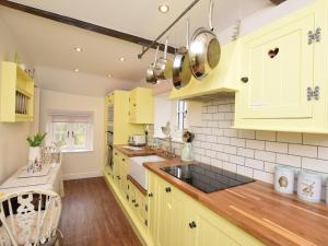 a kitchen with yellow cabinets and a counter at 2 Bed in Otley oc-75268 in Lindley