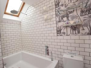 a bathroom with a bath tub and a toilet at 2 Bed in Otley oc-75268 in Lindley