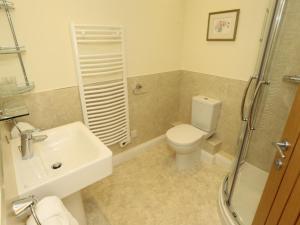 a bathroom with a toilet and a sink and a shower at 3 Bed in Bedale oc-g0095 in Crakehall +22 photos