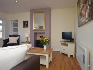 a living room with a couch and a table with a television at 2 Bed in Kewstoke oc-57144 in Weston-super-Mare