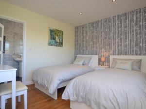 a bedroom with two beds and a sink at 2 Bed in Kewstoke oc-57144 in Weston-super-Mare