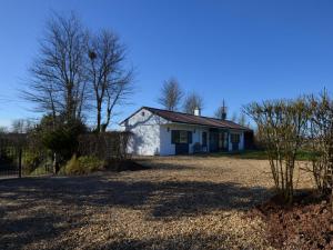 a white house with a fence in a yard at 2 Bed in Kewstoke oc-57144 in Weston-super-Mare