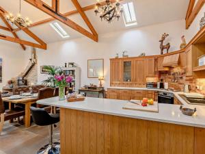 a large kitchen with wooden cabinets and a large island at 3 Bed in Beadnell oc-cn037 in Beadnell