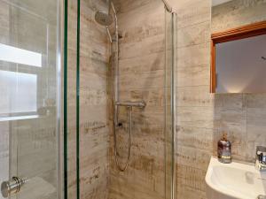a bathroom with a shower and a sink at 3 Bed in Beadnell oc-cn037 in Beadnell +20 photos