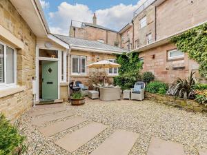 a courtyard in a home with a green door at 3 Bed in Beadnell oc-cn037 in Beadnell
