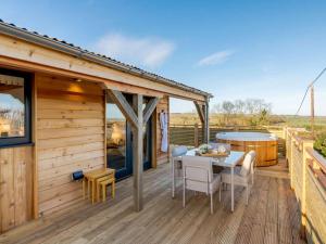 a wooden cabin with a table and chairs on a deck at 2 Bed in Leyburn oc-91102 in Finghall