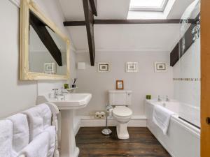 a bathroom with a sink and a toilet and a tub at 2 Bed in Bishop Auckland oc-93111 in Westgate +16 photos