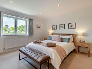 a bedroom with a large bed and a window at 4 Bed in Swanage oc-dc217 in Langton Matravers