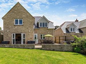 a brick house with a patio and a fence at 4 Bed in Swanage oc-dc217 in Langton Matravers